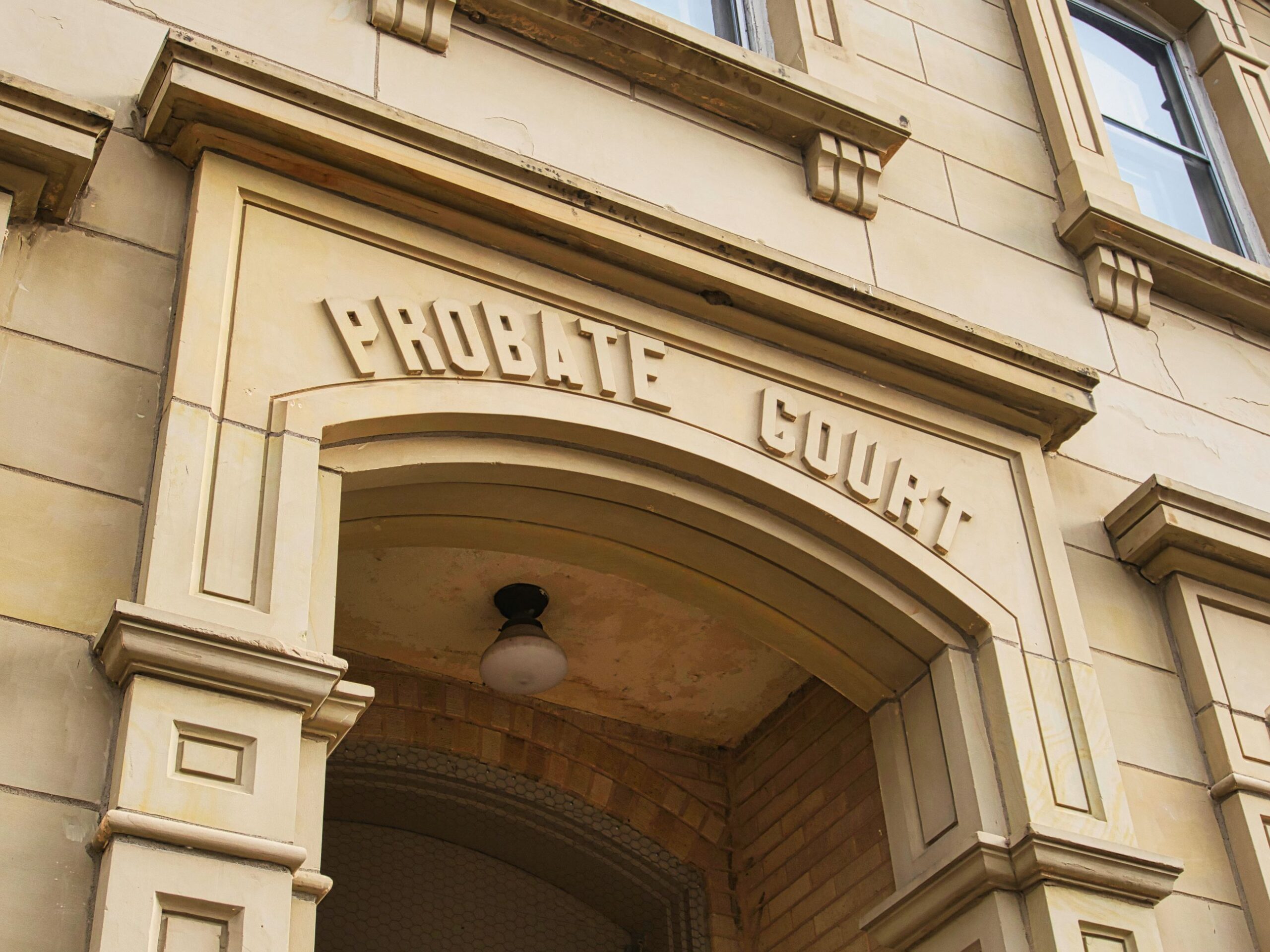 A tan color building with the name Probate Court above an arched doorway